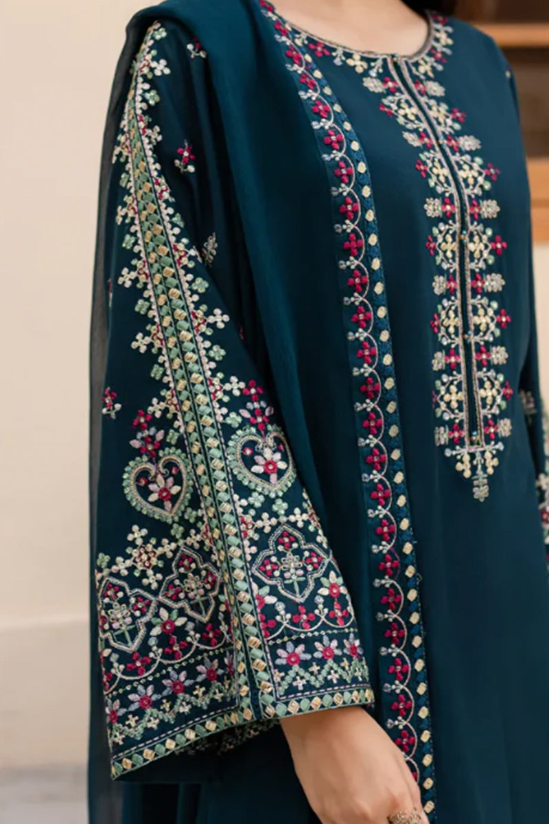 Dark green embroidered garment with intricate patterns on a neutral background