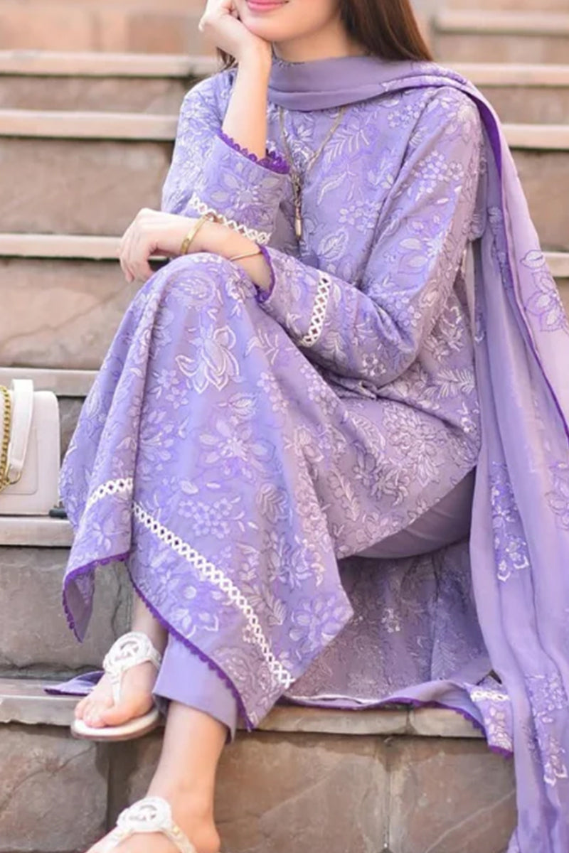 Woman in a lavender traditional outfit sitting on steps