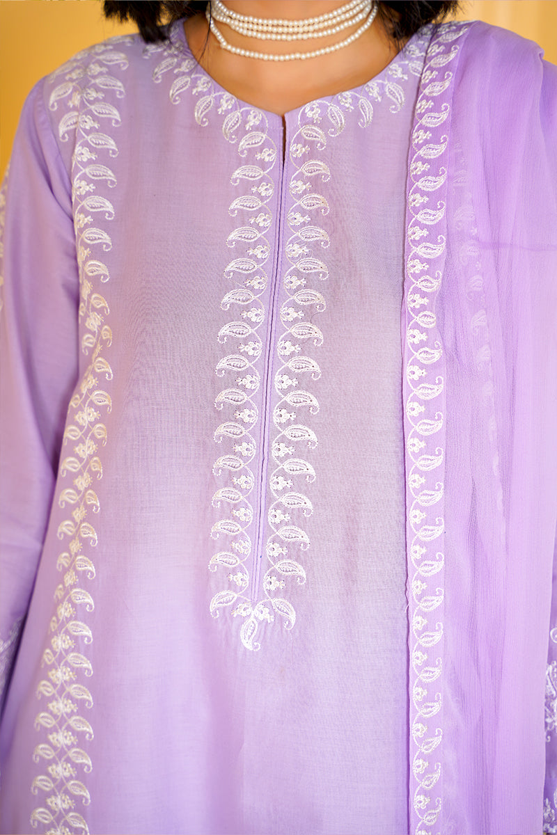 Lavender outfit with intricate white embroidery on a yellow background
