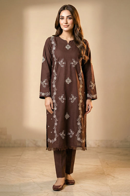 Woman wearing a brown embroidered kurta with pants against a neutral background