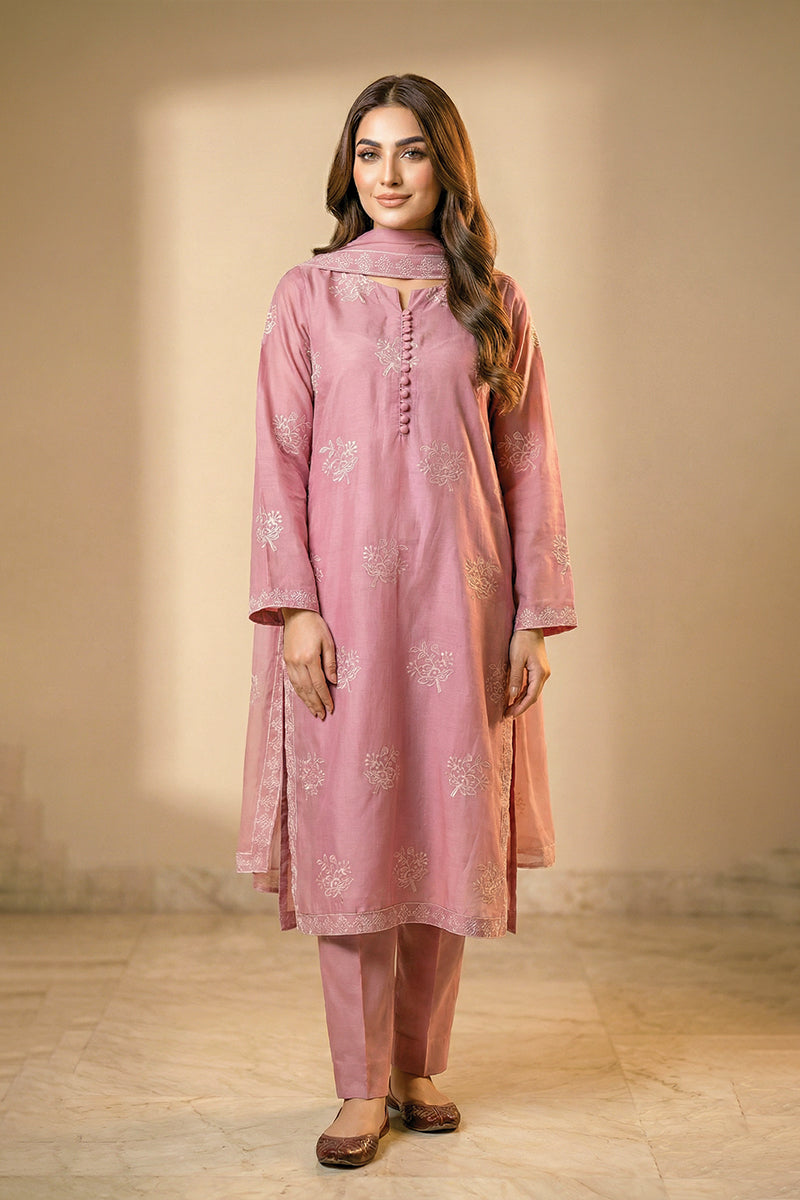 Woman wearing a pink traditional outfit with a plain background