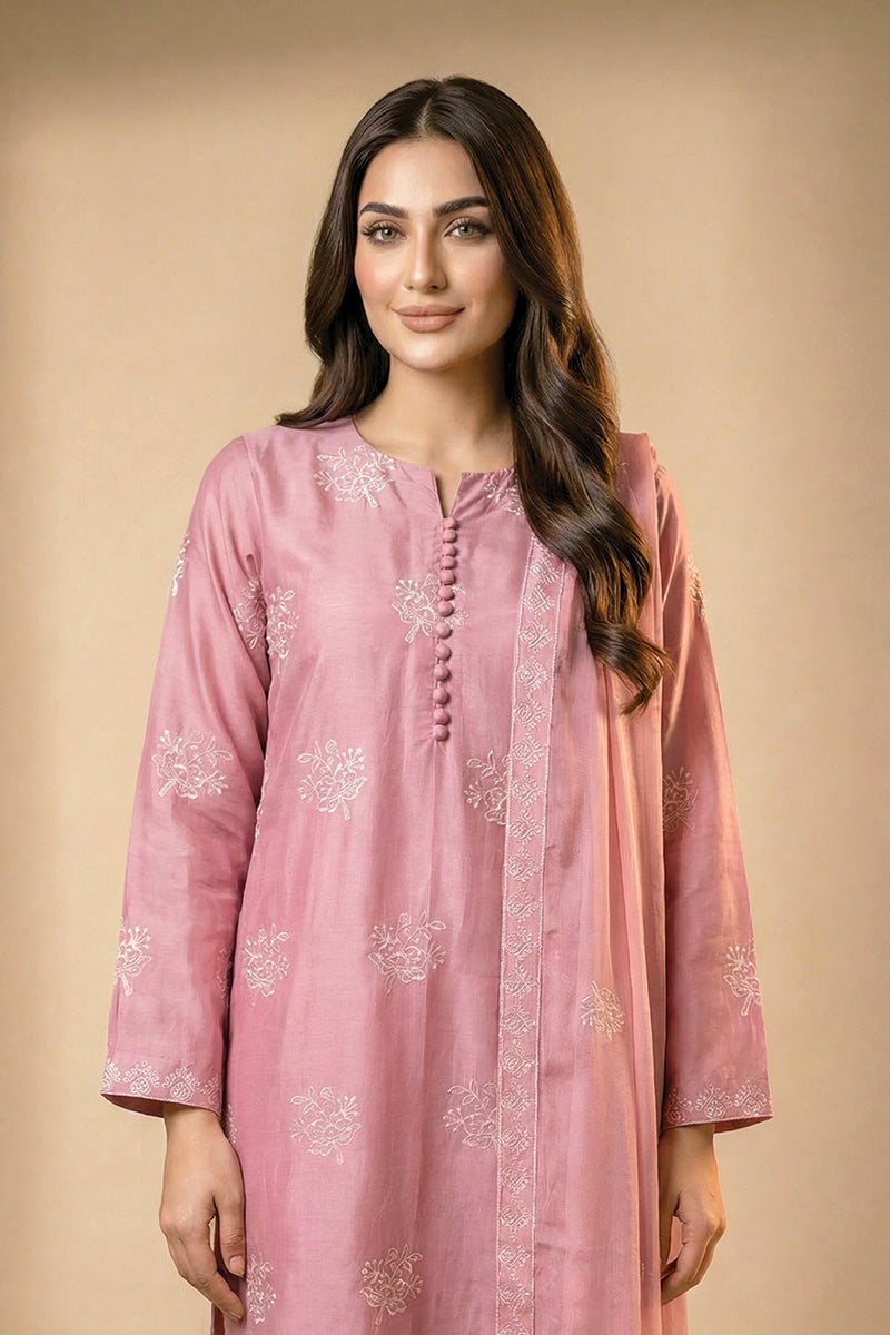 Woman wearing a pink traditional outfit with floral patterns on a beige background