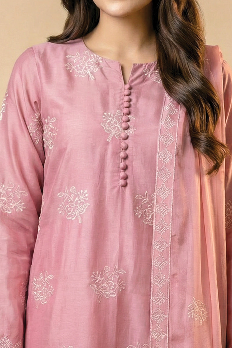 Close-up of a pink embroidered traditional outfit with a beige background
