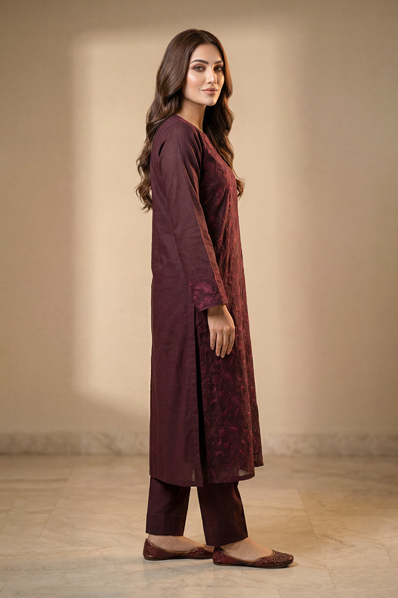 Woman wearing a long Purple dress with a plain background