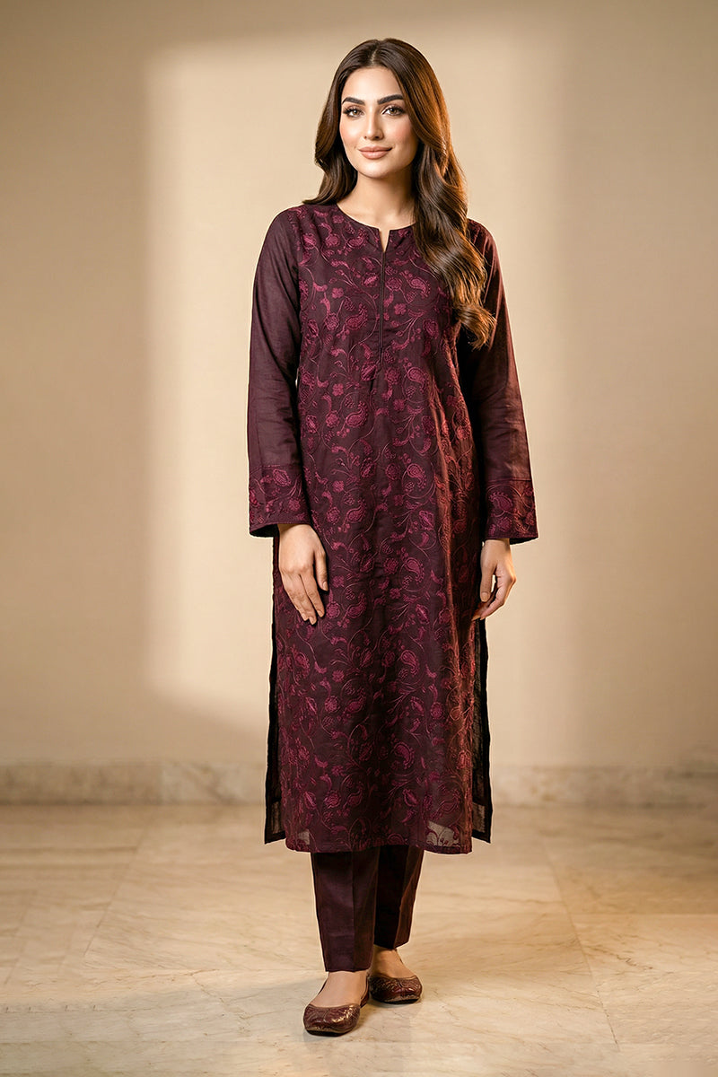 Woman wearing a purple kurta with floral pattern against a beige background