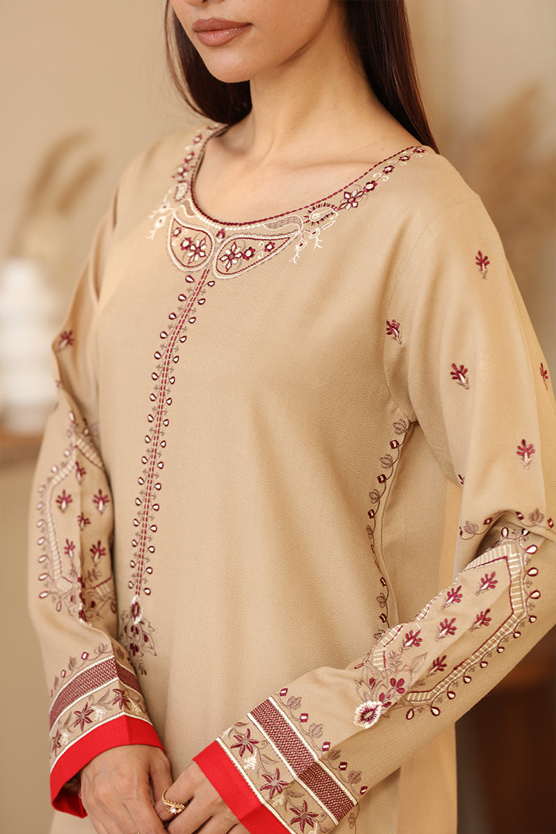 Beige embroidered garment with red and white details on a neutral background