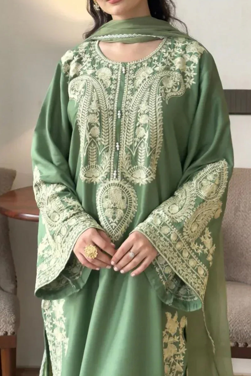 Green embroidered traditional outfit with a matching scarf.