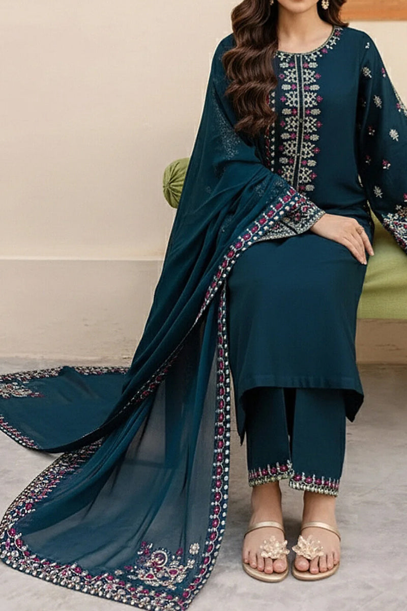 Woman wearing a teal embroidered outfit with a matching dupatta on a neutral background