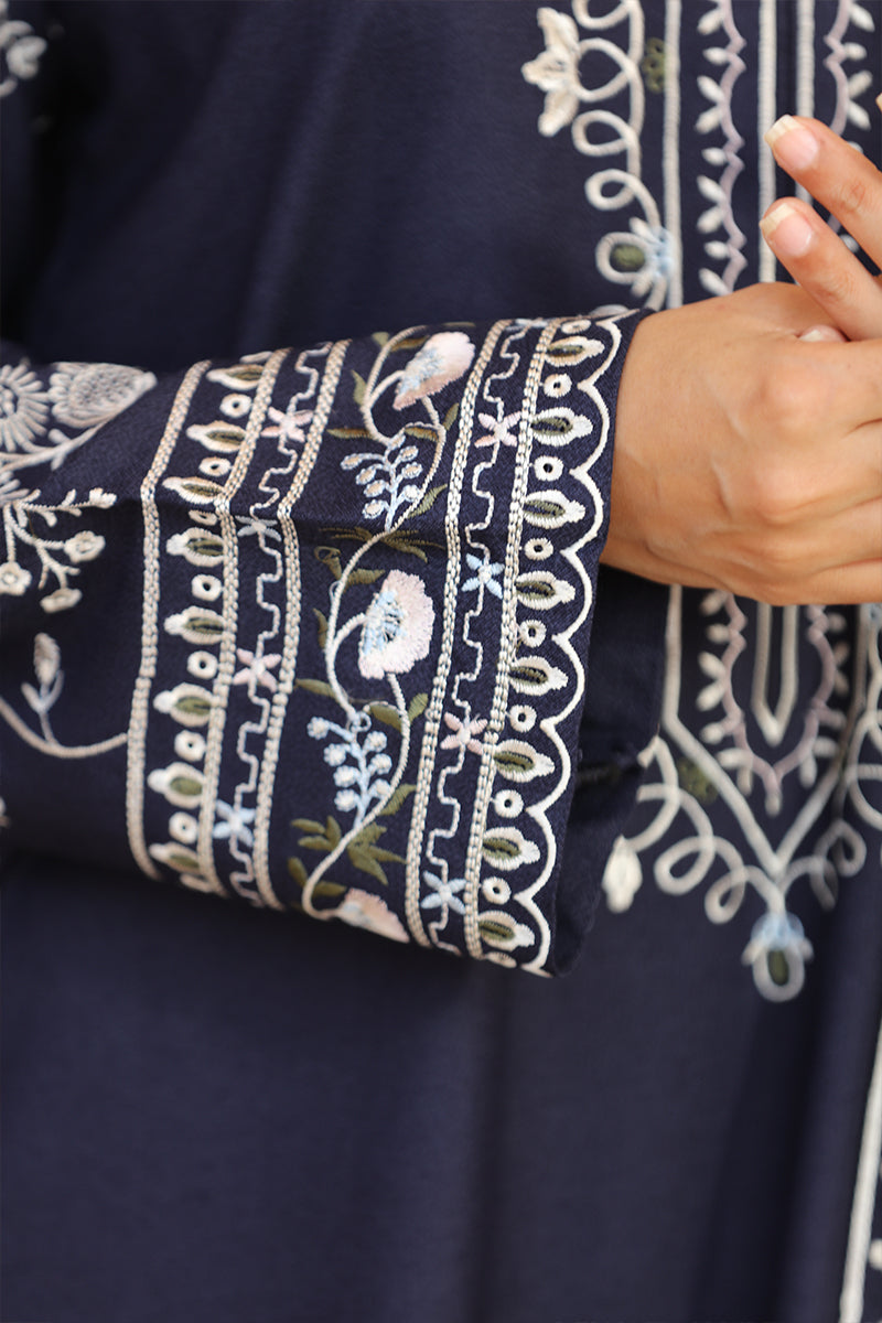 Navy blue fabric with intricate white embroidery on a plain background