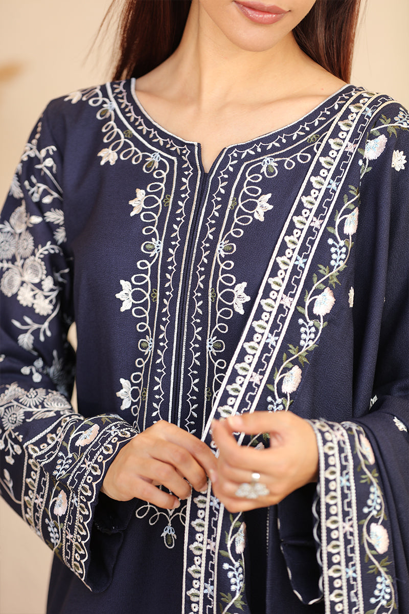 Navy blue embroidered garment with white patterns on a neutral background