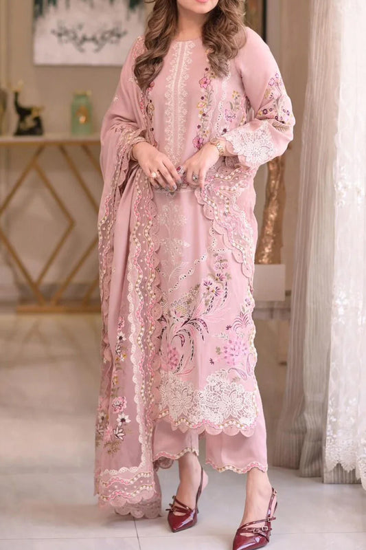 Woman wearing a pink embroidered outfit in an indoor setting