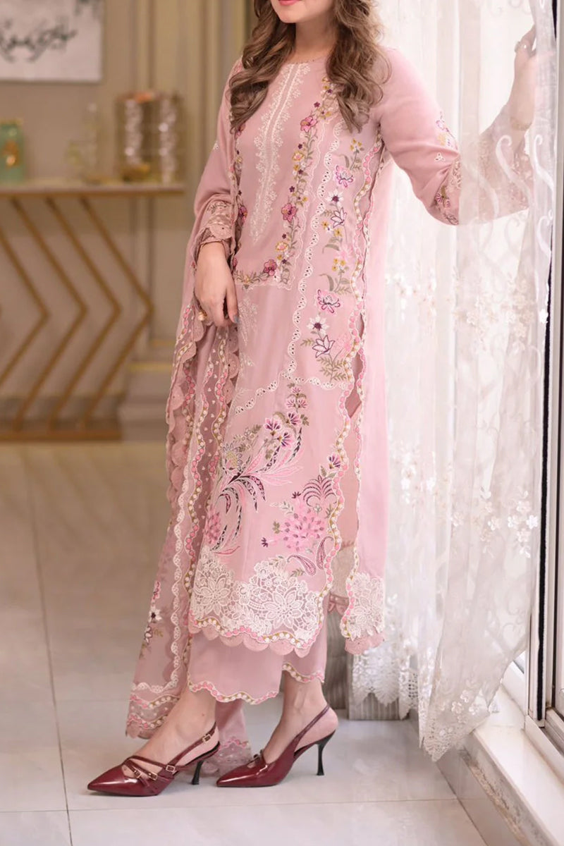 Woman wearing a pink embroidered outfit with red shoes in a room.