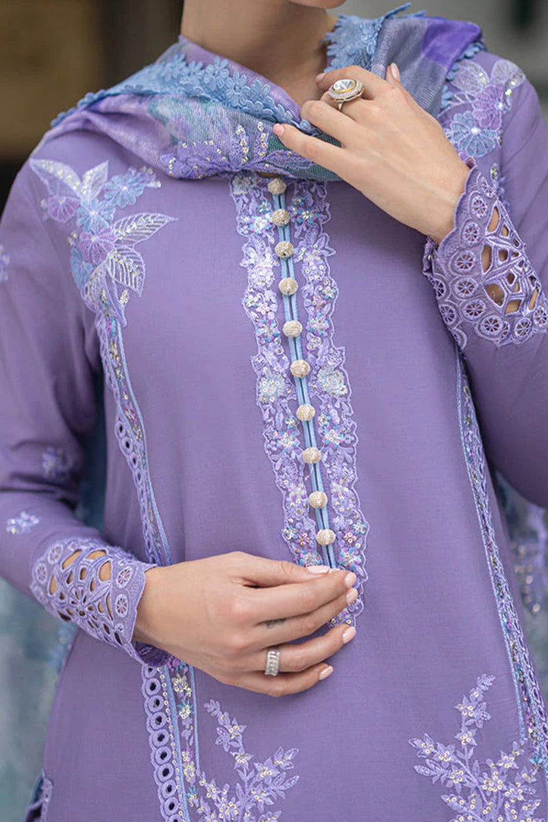 Purple embroidered garment with floral patterns and a ring on a blurred background