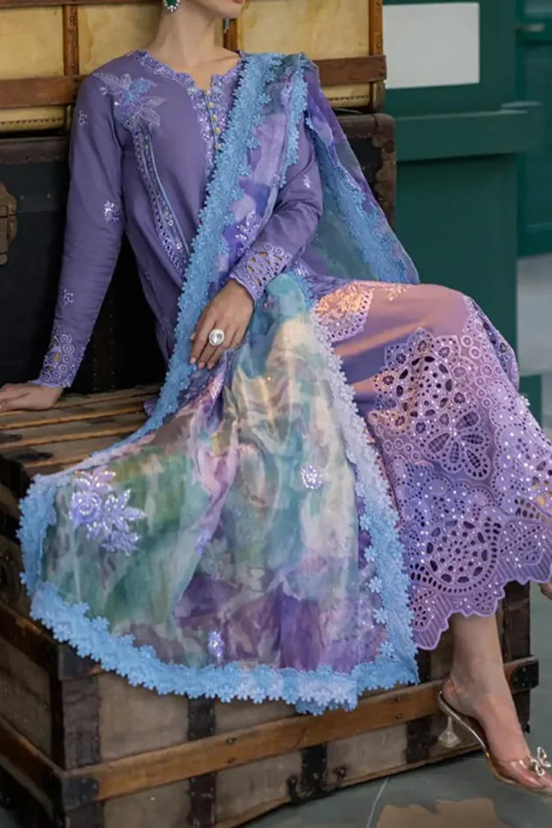 Woman wearing a colorful embroidered outfit with a focus on intricate patterns and textures.