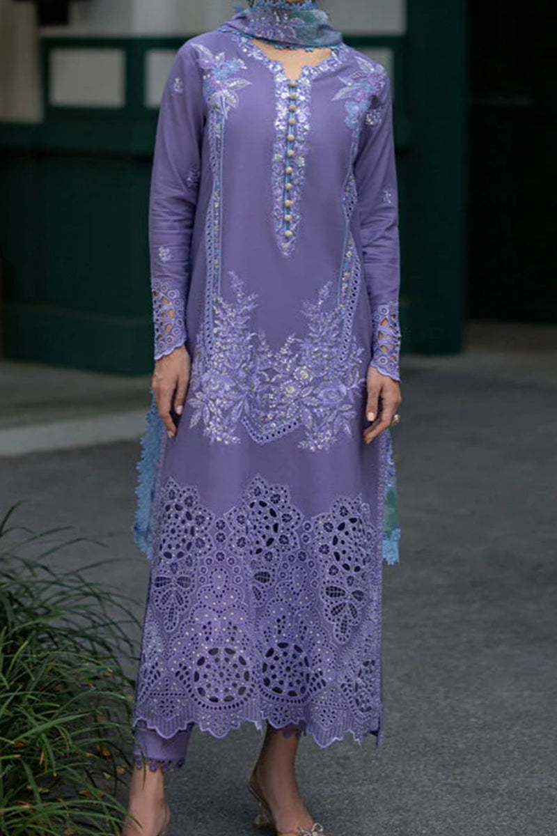 Person wearing a long, embroidered purple dress with a matching headscarf.