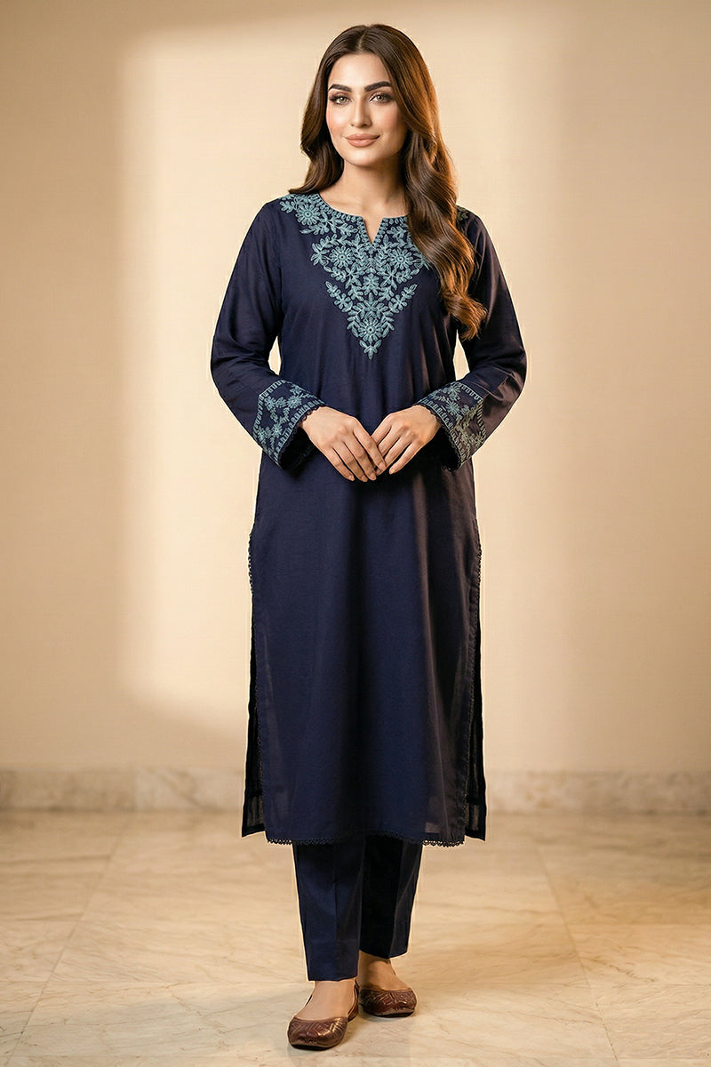 Woman wearing a navy blue traditional outfit with intricate patterns on a beige background